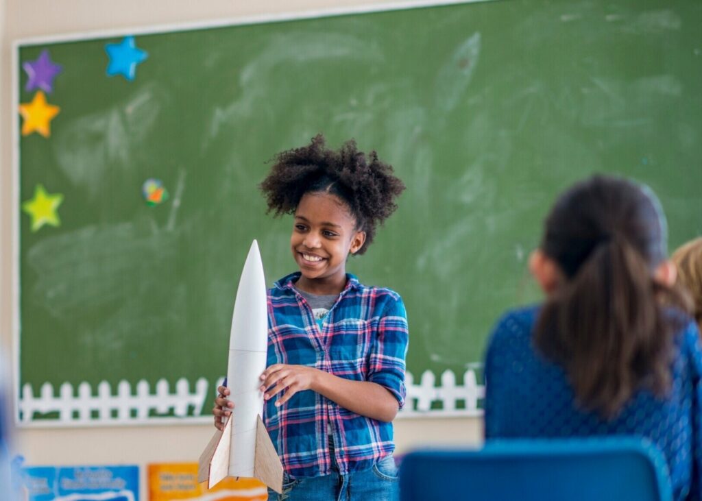 girl with rocket during show and tell