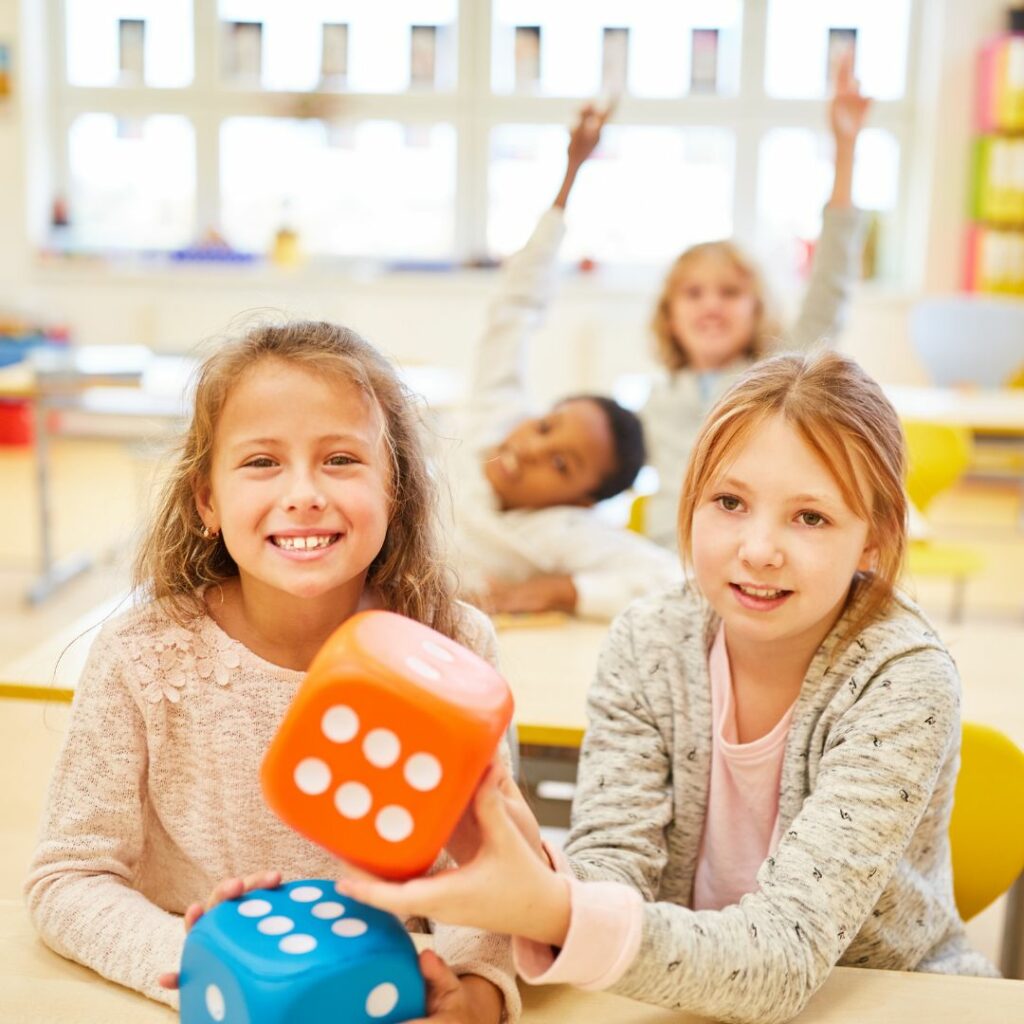 kids using dice during math block