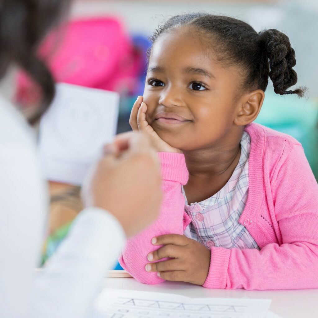 girl reading alphabet flashcards