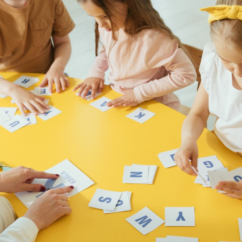 kids spelling with alphabet flashcards